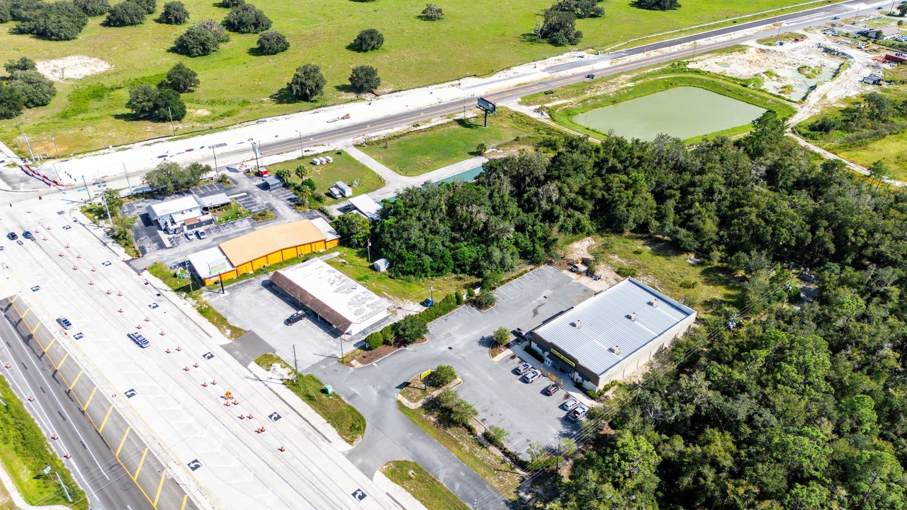 Aerial of storefront and wooded rear